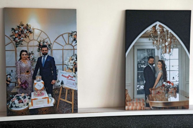 Portraits of Iraqi Kurdish migrant Maryam Nuri Hama Amin and her fiance are placed in her bedroom during a condolence ceremony following her death while trying to cross into Europe, in the Kurdish town of Soran on November 27, 2021. (AFP)