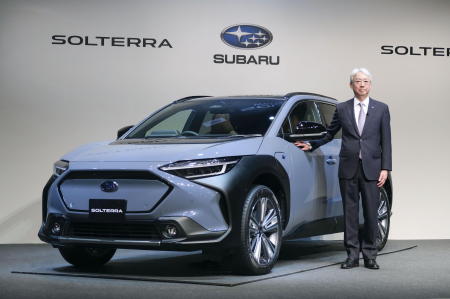 Subaru Corp. President and CEO Tomomi Nakamura stands next to the first all-electric vehicle (EV) Solterra during an unveiling event in Tokyo, Japan, November 11, 2021, in this photo taken by Kyodo. (Reuters)