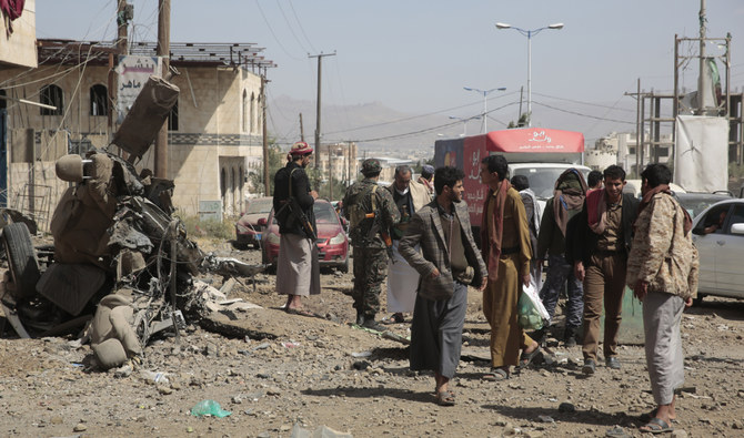 People inspect the site of an airstrike by coalition forces in Sanaa, Yemen, Thursday, Nov, 11, 2021. (AP)
