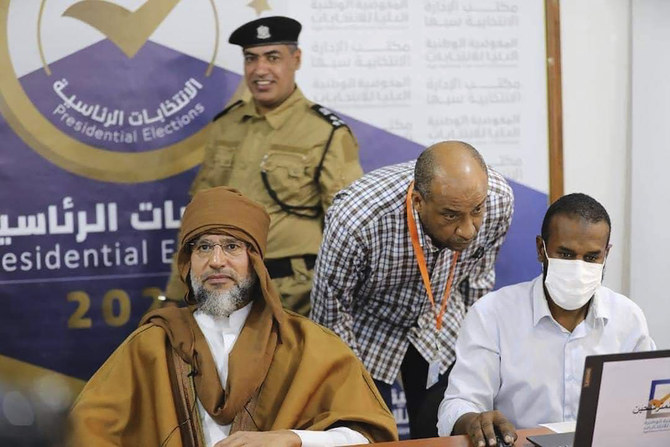 Saif al-Islam, left, the son and one-time heir apparent of late Libyan dictator Muammar Gaddafi registers his candidacy for the country’s presidential elections next month. (AP)