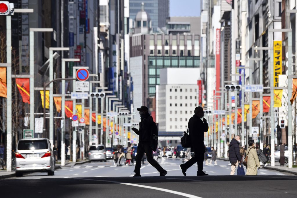 Pedestrians cross a street in the Ginza shopping district in Tokyo. (AFP)