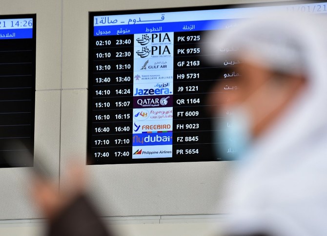 People wait for the arrival of relatives at King Khalid International Airport in the Saudi capital Riyadh on the first commercial flight from Qatar, on January 11, 2021. (AFP)