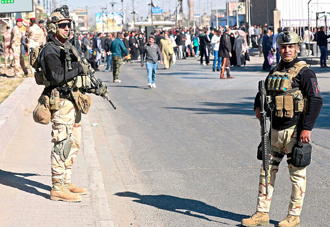 Iraqi security forces stand guard during Friday prayers in Baghdad’s Sadr City district as violence continues to affect several areas of the country. (AFP)