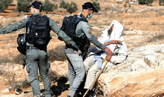 A Palestinian scuffles with Israeli border police officers as Israeli machinery demolishes a Palestinian house in the Israeli-occupied West Bank. (Reuters)