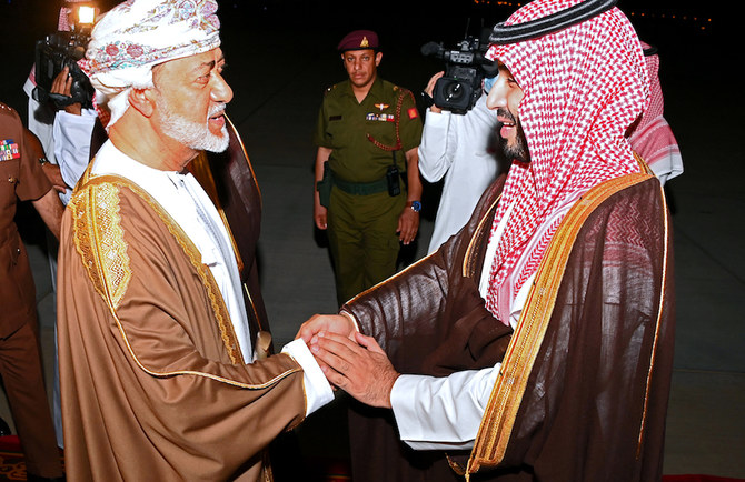 Saudi Crown Prince Mohammed bin Salman is welcomed by the Sultan of Oman, Haitham bin Tariq, upon his arrival at the airport in the Omani capital Muscat on December 6, 2021. (AFP)