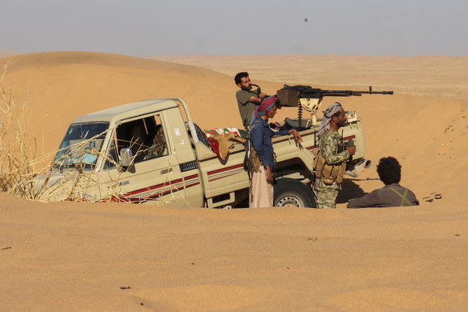 Pro-government tribal fighters take position in a desert area southeast of Marib, Yemen Dec. 6, 2021. (Reuters)