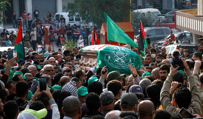 Mourners, including fighters, take part in a funeral procession for Hamza Ibrahim Shahin, a member of the Hamas movement ruling in the Gaza Strip, in the Burj Al-Shamali camp for Palestinian refugees on December 12, 2021. (AFP)