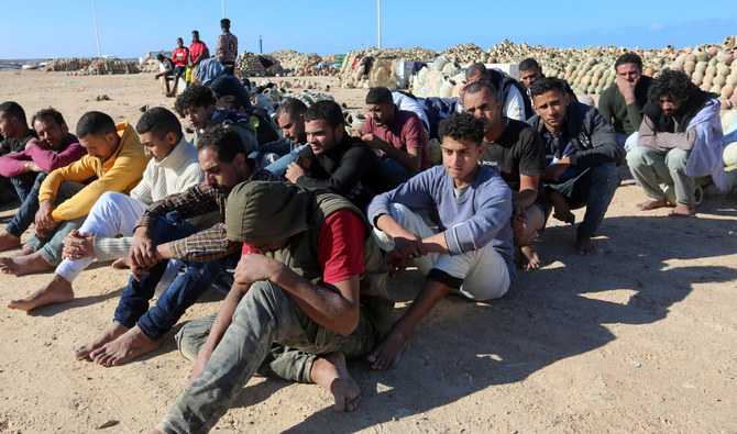 Migrants rescued by Tunisia's national guard during an attempted crossing of the Mediterranean by boat, rest on the beach at the port of el-Ketef in Ben Guerdane in southern Tunisia, on December 15, 2021. (AFP)