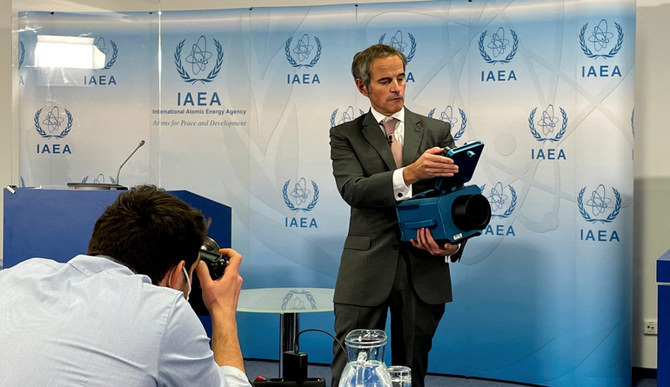 IAEA Director General Rafael Grossi presents a surveillance camera at the agency's headquarters during a news conference in Vienna, Austria, on Dec. 17, 2021. (REUTERS/Francois Murphy)