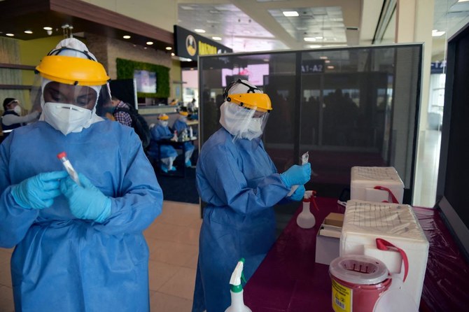 (FILES) In this file photo taken on June 01, 2020 Health Ministry personnel test passengers for COVID-19 with PCR tests at Quito’s International Airport as Ecuador resumes domestic flights amid the novel coronavirus pandemic. (AP)