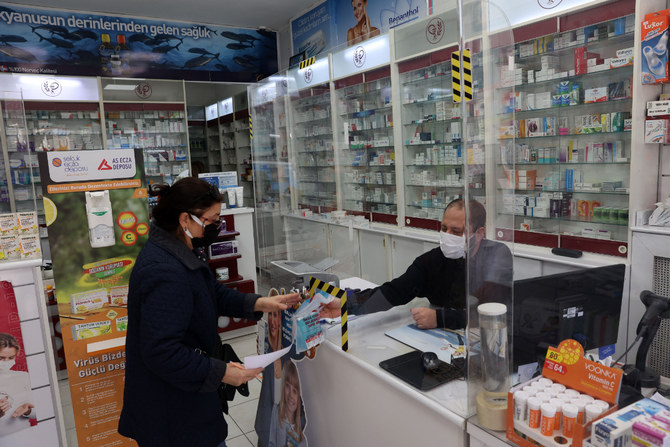 A customer buys medicines at a pharmacy in the Turkish capital Ankara on Dec. 13, 2021. (Photo by Adem Altan / AFP)