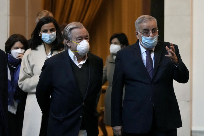 Lebanese Foreign Minister Abdallah Bouhabib speaks with UN Secretary-General Antonio Guterres, upon his arrival at the Rafik Hariri International Airport in Beirut, Lebanon, Sunday, Dec. 19, 2021. (AP)