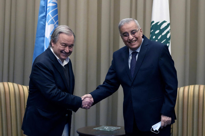 Lebanese Foreign Minister Abdallah Bouhabib shakes hand with UN Secretary-General Antonio Guterres, upon his arrival at the Rafik Hariri International Airport in Beirut, Lebanon, Sunday, Dec. 19, 2021. (AP)