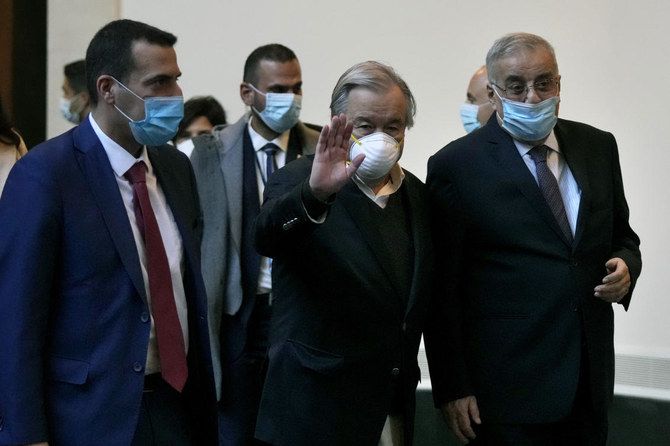 UN Secretary-General Antonio Guterres gestures to journalists as he walks with Lebanese Foreign Minister Abdallah Bouhabib upon his arrival at the Rafik Hariri International Airport in Beirut, Lebanon, Sunday, Dec. 19, 2021. (AP)