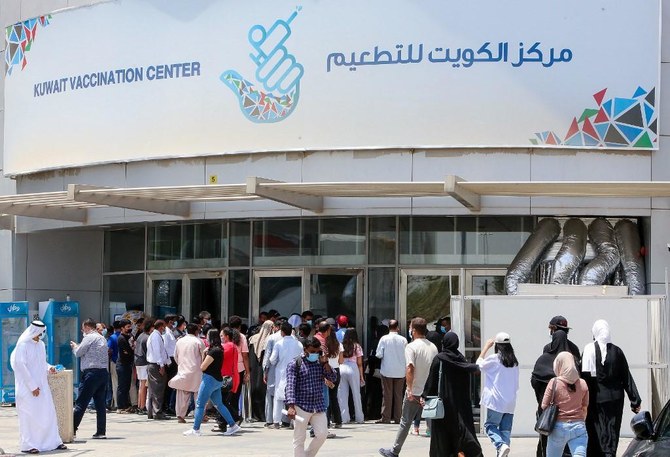 People queue to receive a dose of the COVID-19 vaccine at an inoculation centre in Kuwait City. (File/AFP)