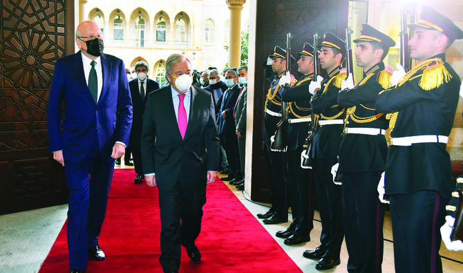 Lebanese Prime Minister Najib Mikati and UN Secretary-General Antonio Guterres review an honor guard at the government house in Beirut on Monday. (AP)