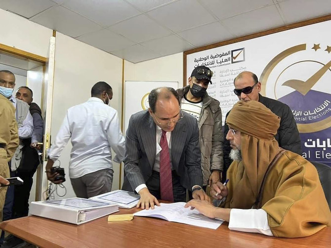 In this Nov. 14 photo, Seif al-Islam (right) the son and one-time heir apparent of late Libyan dictator Muammar Qaddafi, registers his candidacy for the country's presidential elections. (AP)