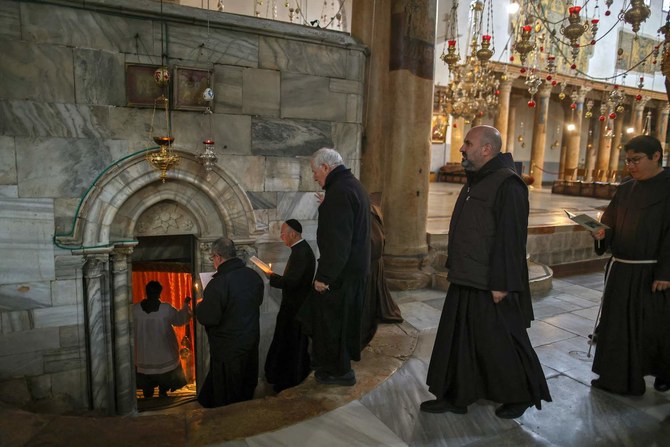 Latin Catholic clergies gather at the Church of the Nativity in the city of Bethlehem in the occupied West Bank on December 21, 2021. (AFP)