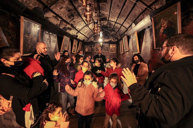 Christian worshippers pray inside the Grotto at the Church of the Nativity in Bethlehem in the occupied West Bank on December 19, 2021. (AFP)