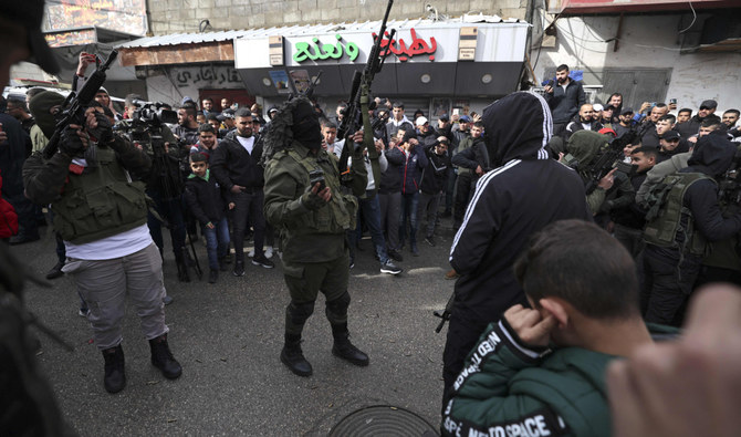 Militants of the Aqsa Martyrs' Brigades fire their guns during the funeral of Palestinian Mohammed Issa Abbas, who reportedly fired on Israeli troops in the occupied West Bank and was shot dead by Israeli forces, in Ramallah, on Dec. 23, 2021. (AFP)