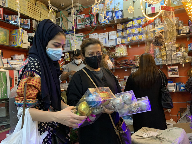 A woman goes Christmas shopping in the Kingdom, with every kind of decoration now freely available. (AFP)