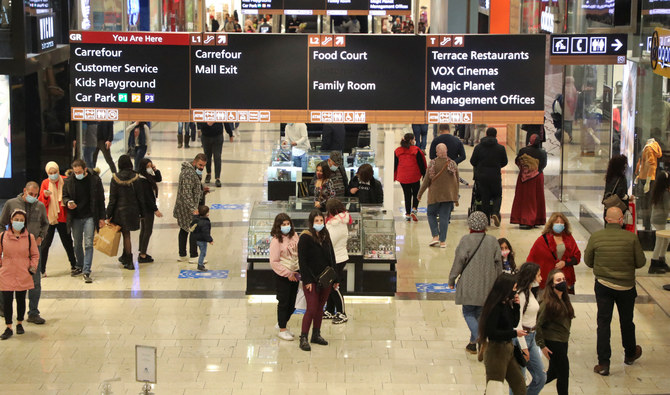 People walk inside a shopping mall during holiday season in Hazmieh, Lebanon December 29, 2021. Picture taken December 29, 2021. (Reuters)