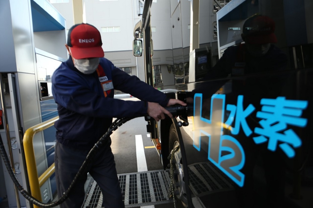 At a gasoline station an employee is seen charging a bus with hydrogen. (ANJ/Pierre Boutier)