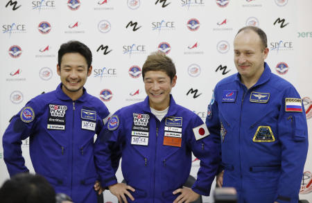 Roscosmos cosmonaut Alexander Misurkin (right), space flight participants Yusaku Maezawa (center) and Yozo Hirano attend a news conference ahead of the expedition to the International Space Station at the Gagarin Cosmonauts' Training Center in Star City outside Moscow, Russia, Oct. 14, 2021. (AP)