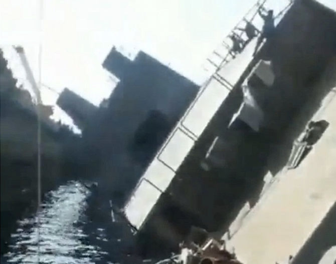 In the video, people can be seen hanging from the railings and at least one person died in the incident, according to reports on social media. (Screenshot)