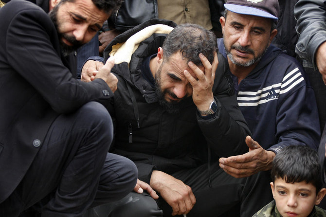 Syrian Maher Al-Abdallah (C) mourns his wife and three children who died in their sleep in Al-Wasta village near Sidon, Lebanon, Sunday, Jan. 2, 2022. (AP)