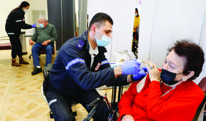 A resident of a private nursing home in the Israeli central coastal city of Netanya receives a fourth Pfizer-BioNTech vaccine against the coronavirus. (AP)