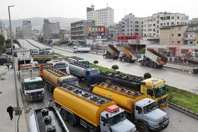 Fuel tankers block a road in Beirut during a general strike on Jan. 13, 2022 by public transport and workers unions over the country's economic crisis. (Anwar Amro / AFP)