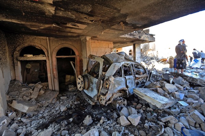 Yemenis inspect the damage following overnight air strikes by the Saudi-led Arab coalition targeting the Houthi-held capital Sanaa, on Jan. 18. (AFP)