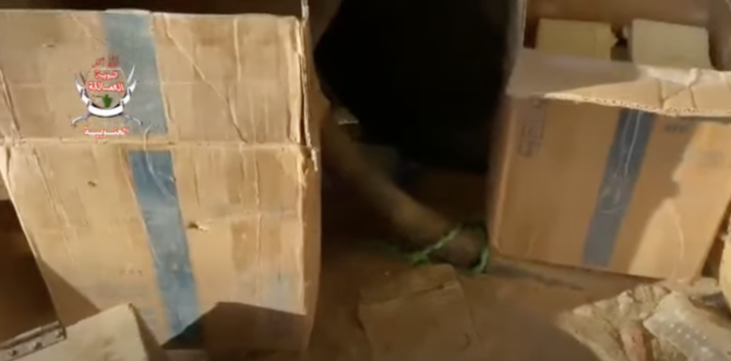 The Giant Brigades discovered hundreds of mines and explosive devices hidden by the Houthis in aid boxes in Harib, Marib. (Screenshot)