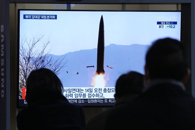 People watch a TV show with a file image of North Korea's missile launch during a news program at the Seoul Railway Station in Seoul, South Korea, on Jan. 20, 2022. (AP Photo/Ahn Young-joon)