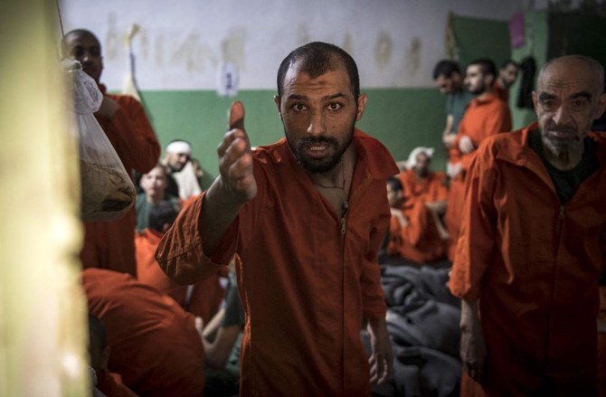 This file photo taken on October 26, 2019, shows men suspected of being affiliated with the Islamic State (IS) group, gathered in a cell of the Sinaa prison in the Ghwayran neighborhood of the northeastern Syrian city of Hasakah. (AFP)