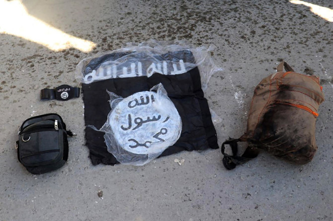 This photo shows the flag of Daesh and and bags taken from fighters who were arrested by the Kurdish-led Syrian Democratic Forces after militants attacked Gweiran Prison, in Hassakeh, northeast Syria. (File/AP)