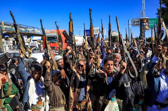 Supporters of Yemen's Houthi terrorist movement brandish weapons during a rally in Sanaa on Jan. 27, 2022. (Photo by Mohammed Huwais / AFP)
