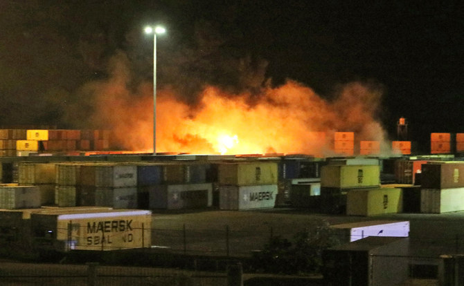 Fire erupts near containers of the Syrian port of Latakia following an Israeli air strike on Dec. 7, 2021. (AFP)
