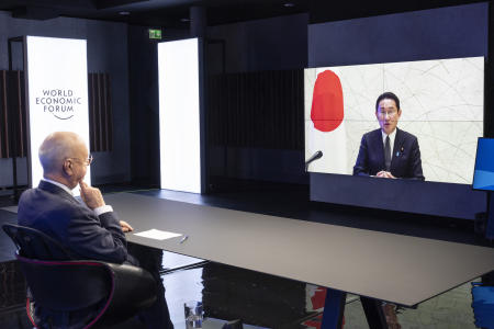 German Klaus Schwab, Founder and Executive Chairman of the World Economic Forum (WEF), listens to Japanese Prime Minister Fumio Kishida (on screen) during the Davos Agenda 2022, in Cologny near Geneva, Switzerland, Tuesday, Jan. 18, 2022. (AP)