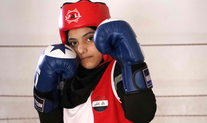 Young boxer Hajer Hussein Ghazi poses as she prepares for an international boxing competition in the city of Amarah in Iraq's southeastern Maysan province on December 19, 2021. (AFP)