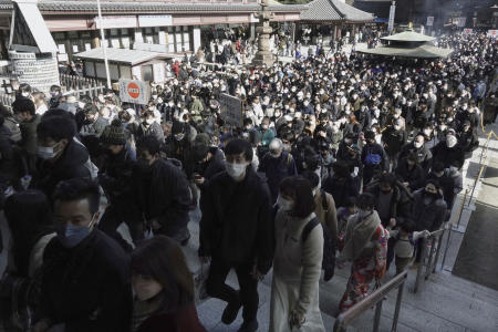 Visitors walk to pray for good luck during their