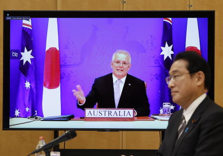 Japan's Prime Minister Fumio Kishida (right) and Australia's Prime Minister Scott Morrison (seen on screen) attend a virtual summit to sign the Reciprocal Access Agreement, at Kishida's official residence in Tokyo, Japan Thursday, Jan. 6, 2022. (AP)