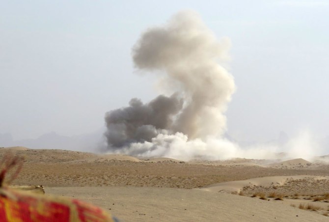 This picture taken from a position held by Yemeni pro-government fighters, shows heavy smoke billowing behind the frontline with Houthi militants, south of Marib, on Jan. 4, 2021. (AFP)