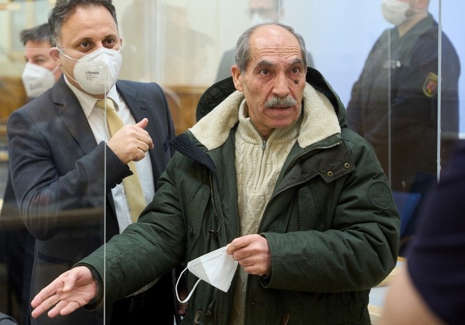 The defendant, former Syrian intelligence officer Anwar Raslan (R), gestures next to one of his lawyers in the courtroom at a courthouse in Koblenz, western Germany, on January 13, 2022. (File/AFP)