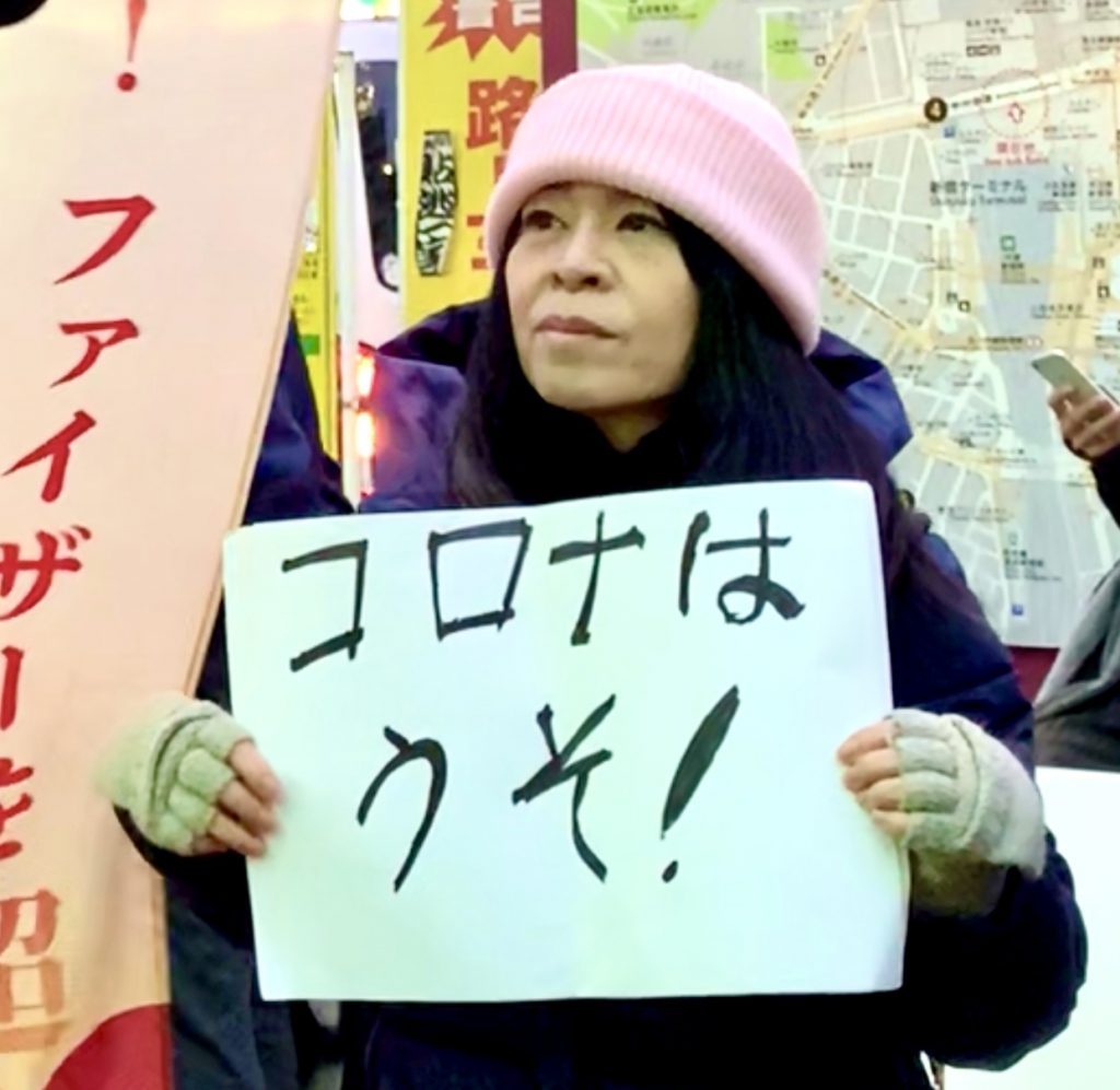An anti-vaccine protester holds a poster saying “Corona is a Lie” during a stand-off between the anti and pro face-mask demonstrators in Shinjuku district in Tokyo, Jan. 30, 2020. (ANJP Photo)