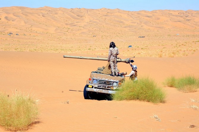 Fighters loyal to Yemen's government man a car-mounted recoilless rifle at the Juba frontline facing the Houthis in Marib. (File/AFP)