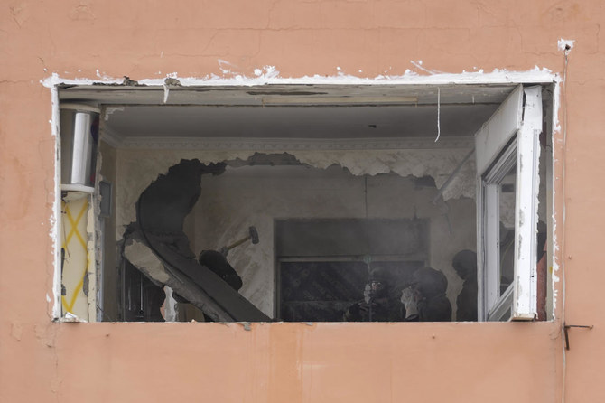 Israeli security forces prepare to seal up the family home of Palestinian militant Fadi Abu Shkhaidem, in the Shuafat refugee camp in Jerusalem on Tuesday. (AP)