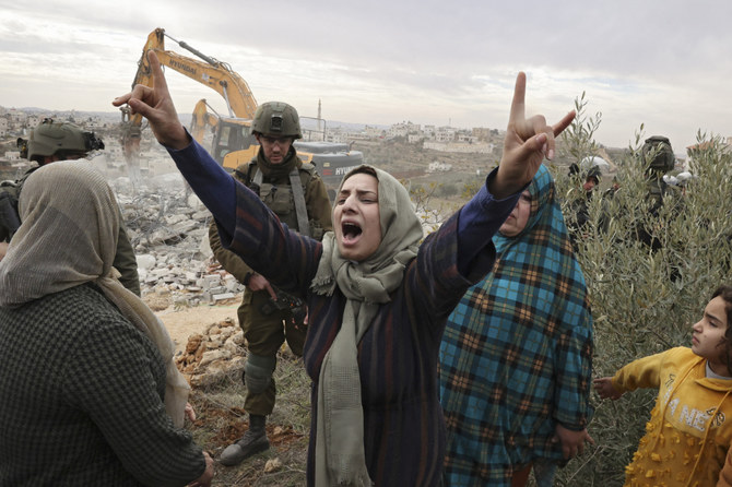 The demolition of Palestinian properties, along with intimidation and legal mechanisms, is regularly used to create adverse living conditions and remove people from their land. (AFP)
