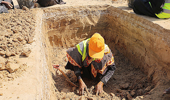 A woman digs salt extraction basins at the Brom Mayfa mining area in Yemen’s southern coastal district of Al-Mukalla in the east central Hadramawt province. (AFP)